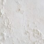 Wall showing peeling and bubbling paint due to water leaks