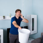 a person on the phone with an emergency plumber