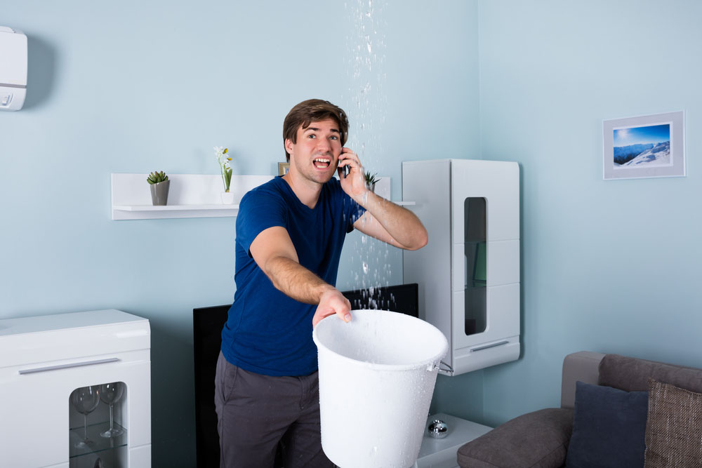 a person on the phone with an emergency plumber a person on the phone with an emergency plumber
