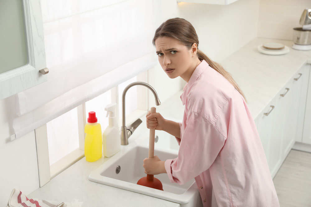 a person dealing with a clogged drain