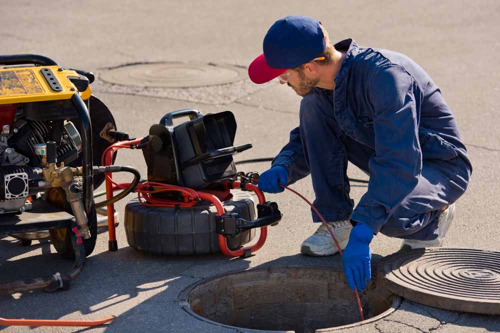 Speedy Rooter technician conducting a sewer camera inspection Speedy Rooter technician conducting a sewer camera inspection