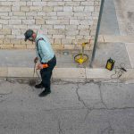 Speedy Rooter technician using acoustic leak detection equipment