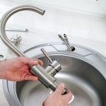 plumber installing a new faucet