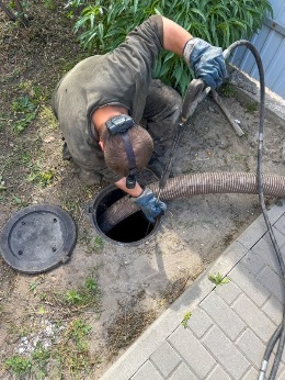 A man is working on a sewer line