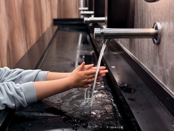 automatic sensor faucet in commercial restroom