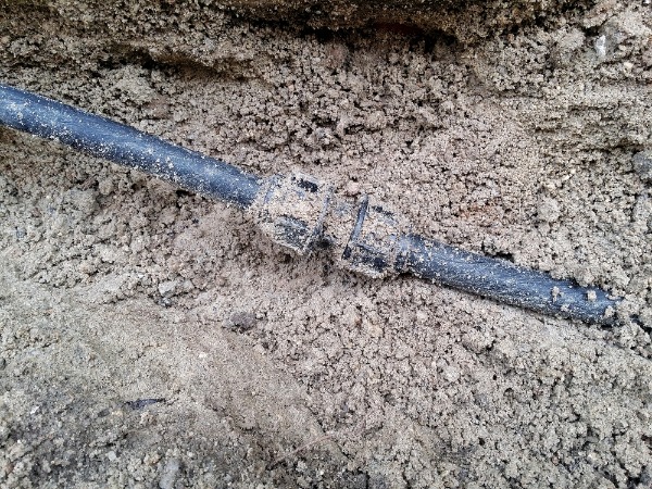 damaged underground water pipe in soil